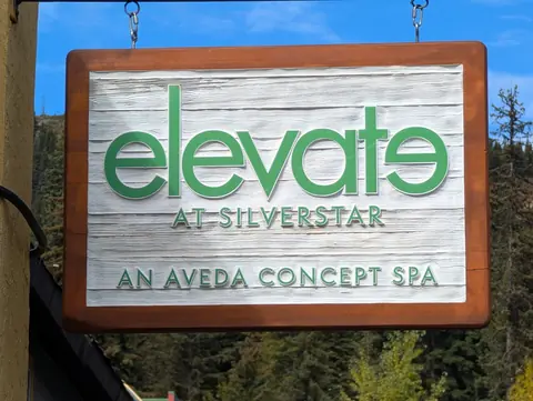 Wooden hanging sign for Elevate at SilverStar spa