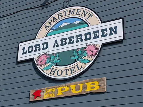 Lord Aberdeen Apartment Hotel sign with a Long John’s Pub sign below