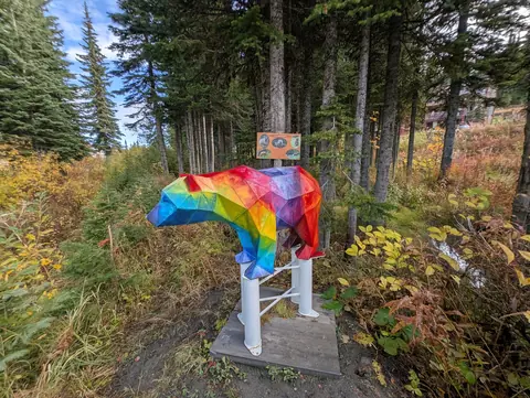 Rainbow faceted bear sculpture among autumn trees on the Bear Byway