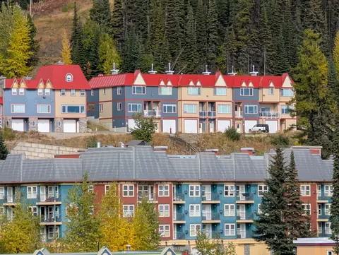 Rows of colourful red-roofed condo buildings on the village hillside
