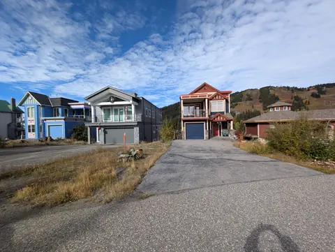 Three modern mountain homes on a paved lane