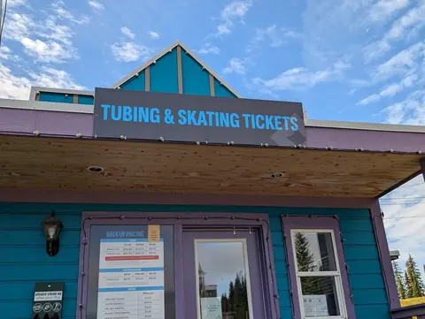 Teal and purple cabin selling tubing and skating tickets